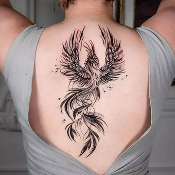 Large phoenix tattoo with spread wings on upper back