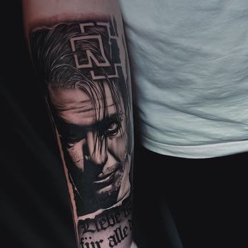 Black and grey portrait forearm tattoo