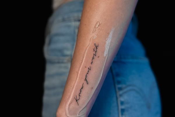 Fine-line forearm tattoo