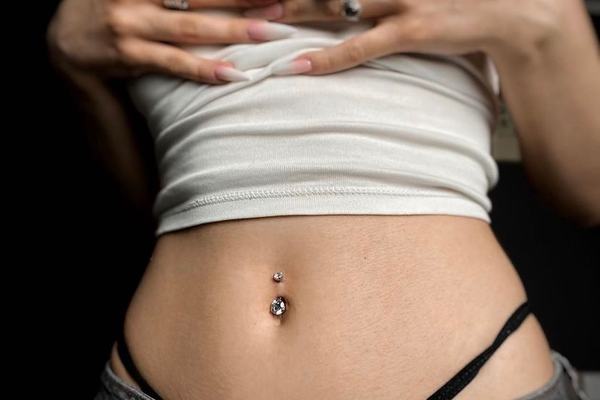 Navel piercing with minimalist jewellery