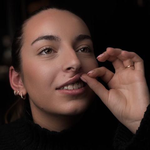 Subtle smiley piercing that adds a playful detail and keeps the overall look light
