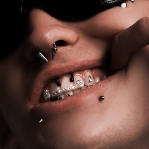 Nose, smiley and microdermal piercings create an unusual mix of accents and make the overall look more expressive.