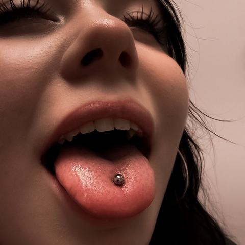 Tongue piercing that adds a distinctive detail and gives the look a clean modern touch